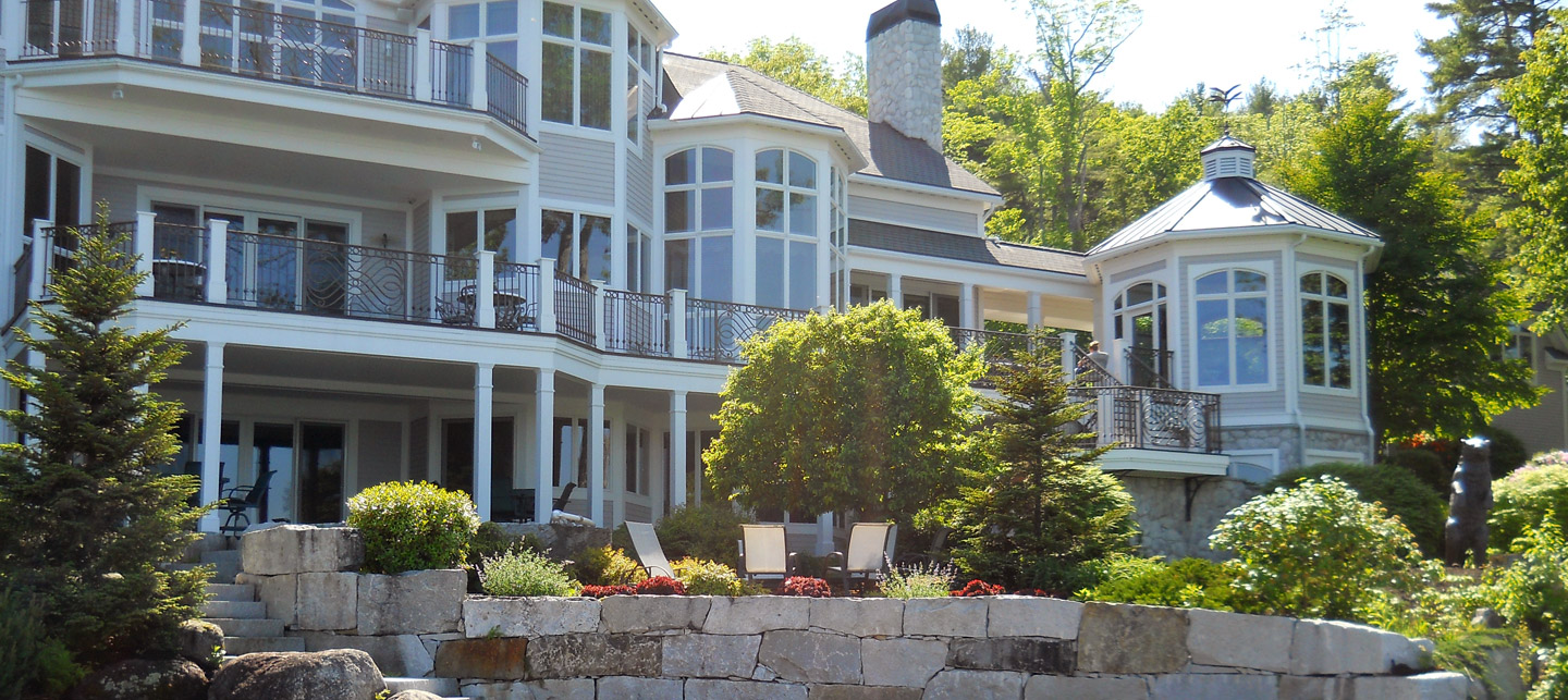 Stone terrace and planted garden borders around a home